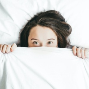 Woman pulling her blanket up to her nose