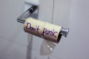 empty toilet paper roll with "Don't Panic" written on it