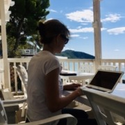 Human language teacher helping student learn while AI tools support practice